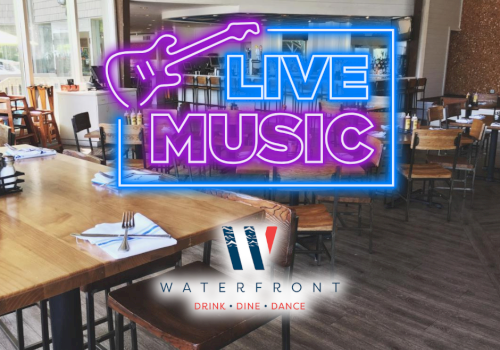 An empty restaurant with a neon sign reading 