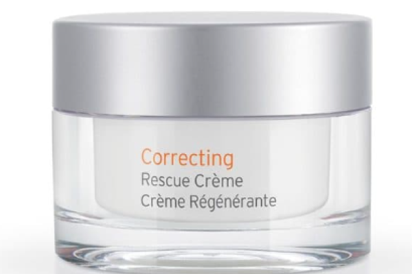 A jar of skin cream with a silver lid labeled 