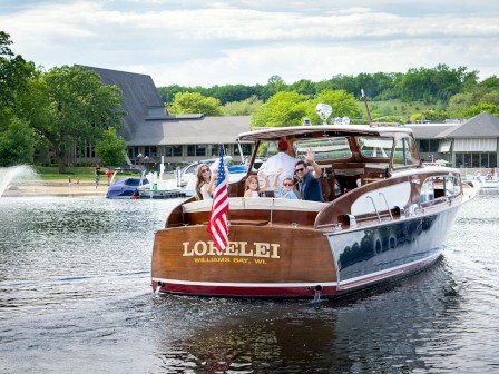 A group of people are on a wooden boat named 
