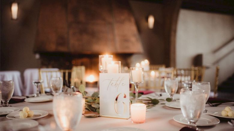A beautifully set table with candles, glassware, plates, and a 